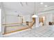 Bright living room with high ceilings, tile floors, a fireplace, and an adjacent staircase at 694 Tomscott Ave, Henderson, NV 89052