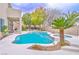 Inviting pool and spa surrounded by a well-maintained patio and lush tropical landscaping at 694 Tomscott Ave, Henderson, NV 89052