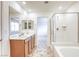 Elegant bathroom showcasing a double vanity, shower, tub, and tile flooring, providing a spa-like retreat at 7006 Feather Hill St, North Las Vegas, NV 89086