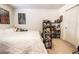 Bedroom with white comforter, artwork and built in shelving at 795 Pickled Pepper Pl, Henderson, NV 89011