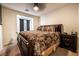 This bedroom has carpet, a ceiling fan and access to a balcony at 795 Pickled Pepper Pl, Henderson, NV 89011