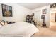 Bedroom features a white comforter, artwork, built in shelving and a guitar at 795 Pickled Pepper Pl, Henderson, NV 89011