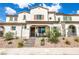 Attractive two-story townhome featuring a covered entryway, a brown tiled roof, and desert rock landscaping at 795 Pickled Pepper Pl, Henderson, NV 89011