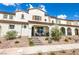 Inviting townhome exterior with covered porch, desert landscaping, and neutral color scheme at 795 Pickled Pepper Pl, Henderson, NV 89011