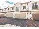 Charming townhome exterior showing garages, decorative balconies, and manicured landscaping at 795 Pickled Pepper Pl, Henderson, NV 89011