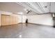 Spacious garage featuring epoxy flooring, built-in cabinets, and convenient water heater at 795 Pickled Pepper Pl, Henderson, NV 89011