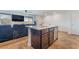 View of the kitchen island with seating, tile floor and open floorplan at 795 Pickled Pepper Pl, Henderson, NV 89011