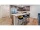 Kitchen with stainless steel appliances, light countertops, island with seating and tile floor at 795 Pickled Pepper Pl, Henderson, NV 89011