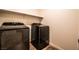 This laundry room features gray washer and dryer units and tile flooring at 795 Pickled Pepper Pl, Henderson, NV 89011