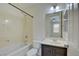 Bathroom with vanity, sink and shower over bath with shower head, featuring a neutral palette at 9003 Greek Palace Ave, Las Vegas, NV 89178