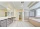 Spacious bathroom with double sinks, separate shower, and soaking tub with a view at 9003 Greek Palace Ave, Las Vegas, NV 89178