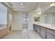 Luxurious bathroom featuring double sinks, stylish cabinetry, and a separate toilet area at 9003 Greek Palace Ave, Las Vegas, NV 89178
