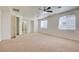 Large bedroom featuring neutral carpet, ceiling fan, and bright windows at 9003 Greek Palace Ave, Las Vegas, NV 89178