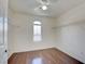 Bright bedroom features hardwood floors, wire shelving, and a charming arched window at 9003 Greek Palace Ave, Las Vegas, NV 89178