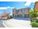 Charming two-story home with a three car garage, a well-manicured lawn and desert landscaping at 9003 Greek Palace Ave, Las Vegas, NV 89178