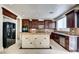 Spacious kitchen features a large center island, dark cabinetry, and stainless steel appliances at 9003 Greek Palace Ave, Las Vegas, NV 89178