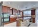 Charming kitchen with custom cabinets, granite countertops, a large island and stainless steel appliances at 9003 Greek Palace Ave, Las Vegas, NV 89178