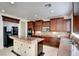 Updated kitchen boasts granite counters, custom cabinets, tile backsplash, and stainless steel appliances at 9003 Greek Palace Ave, Las Vegas, NV 89178