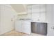 Well-lit laundry room with washer, dryer, sink and storage shelves for convenient household tasks at 9003 Greek Palace Ave, Las Vegas, NV 89178