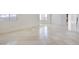 Spacious living room boasts tile flooring and natural light from the window at 9003 Greek Palace Ave, Las Vegas, NV 89178