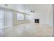 Bright living room with neutral walls, tile floors, fireplace, and natural light from several windows at 9003 Greek Palace Ave, Las Vegas, NV 89178