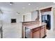 Open-concept kitchen and living space, boasting recessed lighting and a cozy fireplace at 9003 Greek Palace Ave, Las Vegas, NV 89178