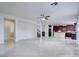 Bright and airy living area with tile floors, open layout, staircase and a kitchen island at 9003 Greek Palace Ave, Las Vegas, NV 89178