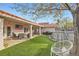 Lush backyard featuring a swing, covered patio, and well-maintained lawn, perfect for outdoor relaxation at 905 White Thunder St, Henderson, NV 89002