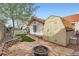 Charming backyard with a fire pit, storage shed, and manicured lawn, perfect for outdoor activities at 905 White Thunder St, Henderson, NV 89002