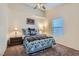 Comfortable bedroom with a ceiling fan, large window, and a stylish bed set at 905 White Thunder St, Henderson, NV 89002
