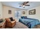 A cozy bedroom with a large window and ceiling fan, perfect for relaxation at 905 White Thunder St, Henderson, NV 89002