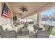 Inviting covered patio with ceiling fans and comfortable wicker furniture, perfect for outdoor entertaining at 905 White Thunder St, Henderson, NV 89002