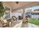 Cozy covered patio featuring comfortable wicker seating and string lights, creating a warm ambiance at 905 White Thunder St, Henderson, NV 89002