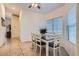Dining room features a table with six chairs, tile flooring and natural light at 905 White Thunder St, Henderson, NV 89002