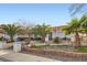 Inviting single-story home with a terracotta tile roof, mature palm trees, and well-maintained landscaping at 905 White Thunder St, Henderson, NV 89002