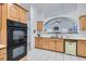 Bright kitchen featuring white countertops, stainless double oven, and light wood cabinetry at 905 White Thunder St, Henderson, NV 89002