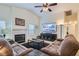 Cozy living room with fireplace, comfortable seating, and vaulted ceilings at 905 White Thunder St, Henderson, NV 89002