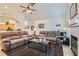 Inviting living room with fireplace, comfortable couches, and open to kitchen at 905 White Thunder St, Henderson, NV 89002