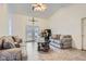 Bright living room featuring neutral tile flooring, high ceilings, and access to the backyard through glass doors at 905 White Thunder St, Henderson, NV 89002