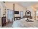Comfortable main bedroom with mounted TV and large windows, creating a cozy and modern space at 905 White Thunder St, Henderson, NV 89002