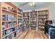 Spacious home office featuring hardwood floors, built-in bookshelves, and ample storage space at 905 White Thunder St, Henderson, NV 89002