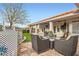 Relaxing outdoor seating area with a stone patio, ideal for enjoying the beautiful backyard at 905 White Thunder St, Henderson, NV 89002