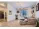 Comfortable sitting area with a window view, a decorative chandelier, and tile floors at 905 White Thunder St, Henderson, NV 89002