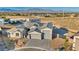 Aerial view showcasing a modern home with a three-car garage and desert landscaping at 9570 Verde Way, Las Vegas, NV 89149