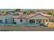 Back exterior with covered patio and desert landscaping at 9570 Verde Way, Las Vegas, NV 89149