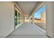 A covered back patio features sleek design and leads to a spacious backyard, perfect for outdoor activities at 9570 Verde Way, Las Vegas, NV 89149