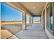 Long, covered back patio, ideal for outdoor dining and entertaining, offering a view of the surrounding landscape at 9570 Verde Way, Las Vegas, NV 89149