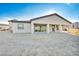View of backyard showcasing covered patio and sliding glass doors for indoor/outdoor living at 9570 Verde Way, Las Vegas, NV 89149