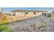 View of the spacious backyard featuring desert landscaping and privacy at 9570 Verde Way, Las Vegas, NV 89149