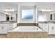 Bright bathroom with double vanity, large tub, and warm lighting at 9570 Verde Way, Las Vegas, NV 89149